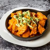 Patatas Bravas · Fried potatoes, tossed in paprika, served over red bell pepper and almond sauce, topped with...