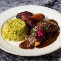 Mole Poblano - D · Tender chicken breast, served with Mexico's unique and traditional Mole Sauce; made with nut...
