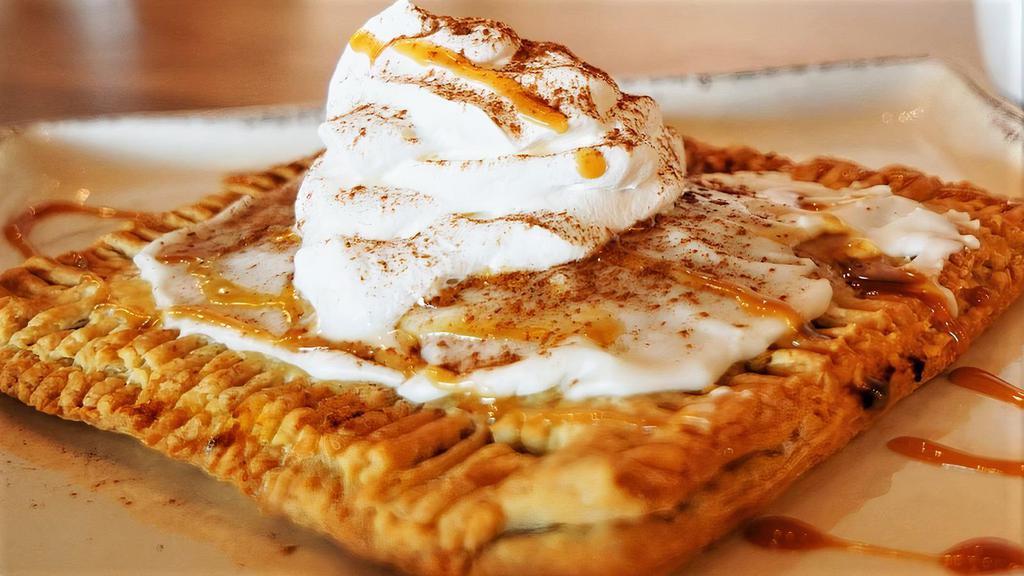 Pumpkin Poptart · Homemade with pumpkin pie filling. Smothered in cinnamon and caramel sauce. Served with whipped cream.