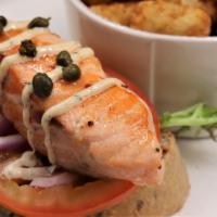 Salmon Ciabatta · Grilled fresh salmon, sliced tomato, mixed greens, red onion, remoulade sauce, capers, on to...