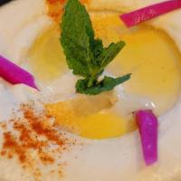 Hummus · Chickpeas purée with tahini sauce lemon juice and a hint of fresh garlic.