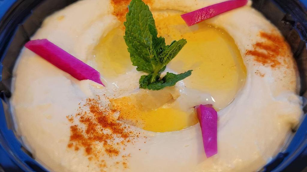 Hummus · Chickpeas purée with tahini sauce lemon juice and a hint of fresh garlic.