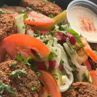 Falafel · Ground chickpeas with herbs and spices cooked in vegetable oil served with tahini sauce, tom...