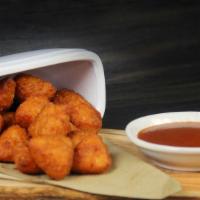 Beer Battered Cheese Curds · Sharp Cheddar Curds, beer battered and fired.