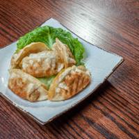Pan-Fried Dumplings · Chicken mix wrapped in a dough and briefly fried. A little larger than a wonton.