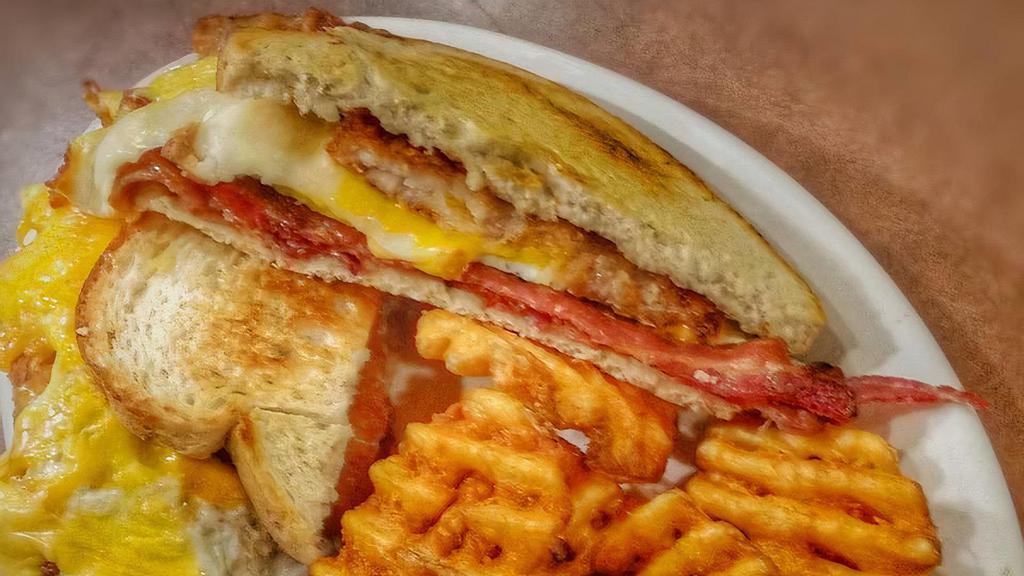 Loaded Grilled Cheese · Eggs, bacon, hash brown, three cheeses.