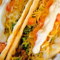 Tacos - Beef, Chicken, Or Bean · Cheese, lettuce, tomato, and sour cream.