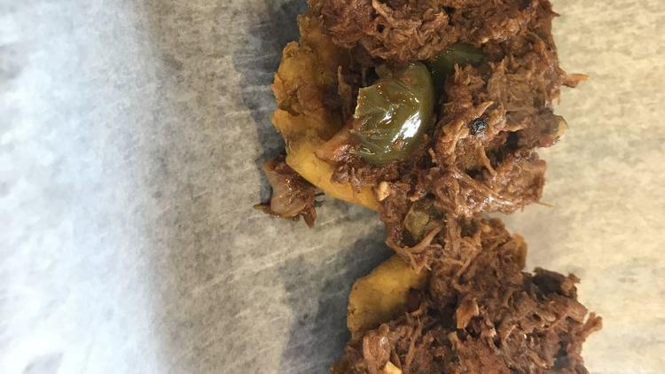 Tostones Rellenos · Four plantains stuffed with picadillo, ropa vieja, pork, and mojo chicken.