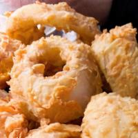 Onion Rings · Sweet onions hand cut, soaked in buttermilk, lightly breaded, flash fried and dusted in our ...