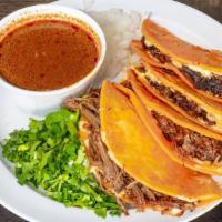 Quesabirrias · 4 corn tortillas filled with beef or lamb birria bathed in birria broth. Served with cilantr...