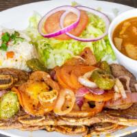 Costillas · Grilled beef ribs cooked with tomatoes, jalapeños and onions. Served with salad, white rice ...
