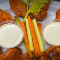Chicken Wings · Order of 6 or 12 chicken wings. Flavors: Buffalo, sweet chili, honey sriracha, and BBQ.