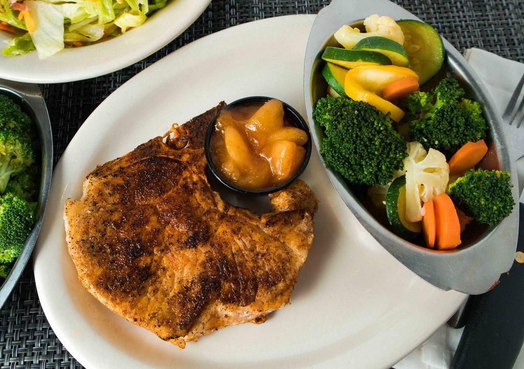 Pork Chops · A pair of juicy center cut, bone-in pork chops grilled just right.   Served with Saucy Cinnamon Apples on the side.