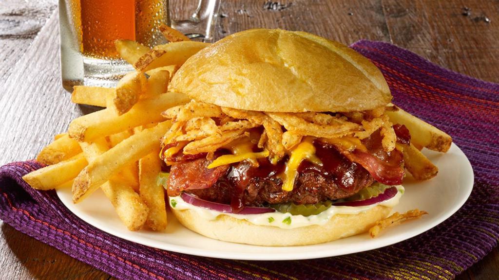 Messy Mike'S Burger · With our hickory BBQ sauce, applewood smoked bacon, melted cheddar cheese and onion straws.    Served on a freshly grilled bun with spicy   green onion mayo, pickles and red  onions.