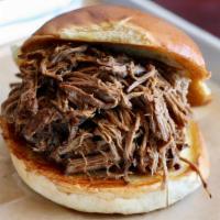 Beef Brisket · Our famous brisket beef,  pulled and piled high, served on a white bun