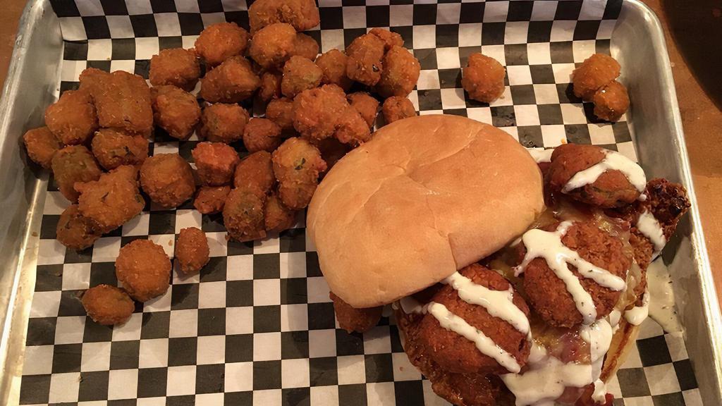 Tangy Bbq Chicken Sandwich · Grilled or Fried breast, tossed in tangy bbq sauce, topped, with swiss cheese, bacon, Fried pickle chips and ranch dressing Served on a toasted bun with choice of one fixin.