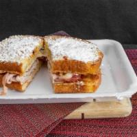 Monte Cristo  · Ham, turkey, swiss cheese,topped with powdered sugar and served with strawberry jam on egg b...