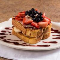 Very Berry Stuffed French Toast · Stuffed with cream cheese filling and topped with fresh berries, bananas and berry compote.