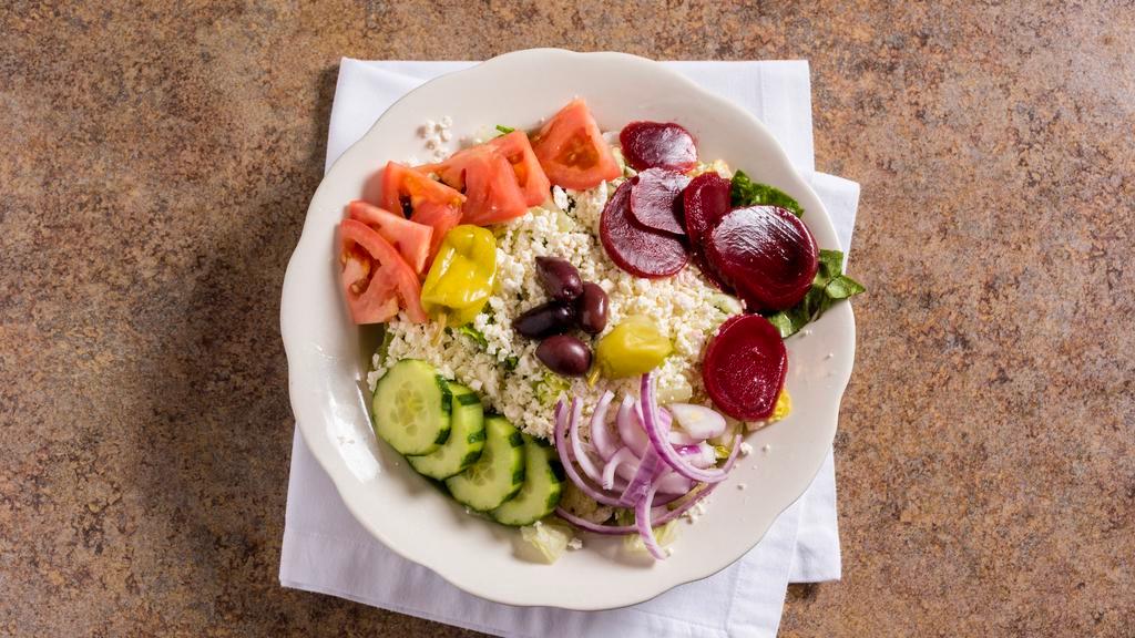Greek Salad · With lettuce, feta cheese, kalamata olives, pepperoncini, onions, tomatoes, beets and cucumbers, served with our greek dressing.