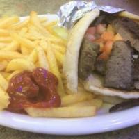 The Original Gyro · Thinly sliced gyro meat, onions and diced tomatoes rolled in a fresh grilled pita and topped...