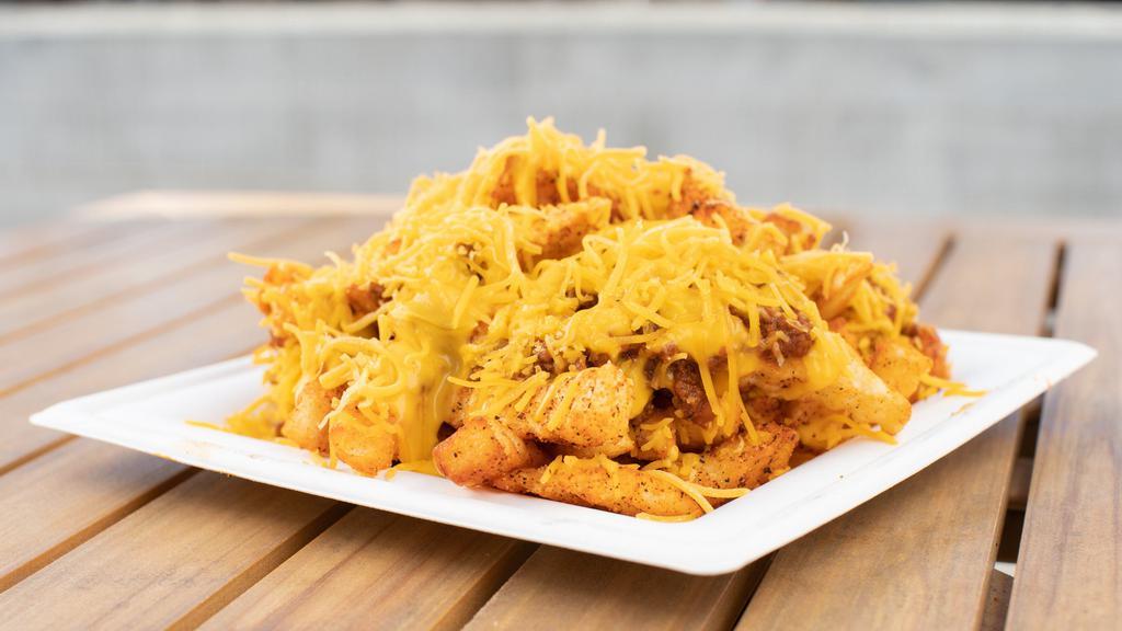 Large Chili Cheese Fries · A half pound of our seasoned crinkle cut fries, cheese sauce, shredded cheese and smothered in our housemade chili.