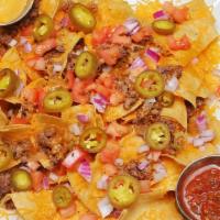 Nacho Supreme · Nacho chips, ground beef, shredded cheese, onions, tomatoes, and jalapenos. Served with sour...