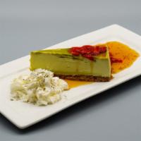 Matcha Cheesecake · Green tea cheesecake, goji berry sauce, and whipped cream.