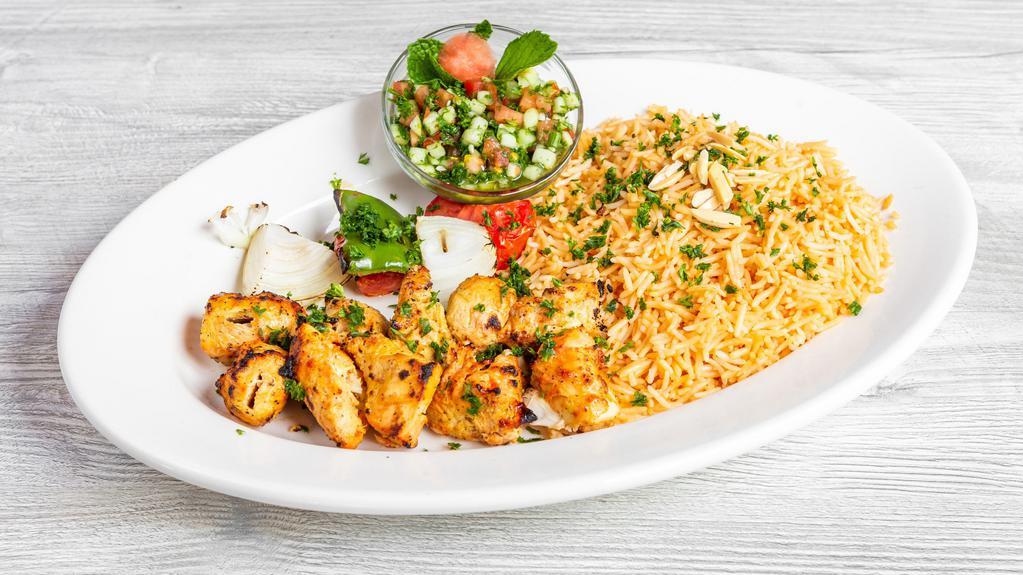 Chicken Shish Tawook / شيش طاووق - Platter · Marinated chicken breast cubes charbroiled to perfection, served with grilled veggies. (two skewers).  Comes with our seasoned rice and your choice of side salad.