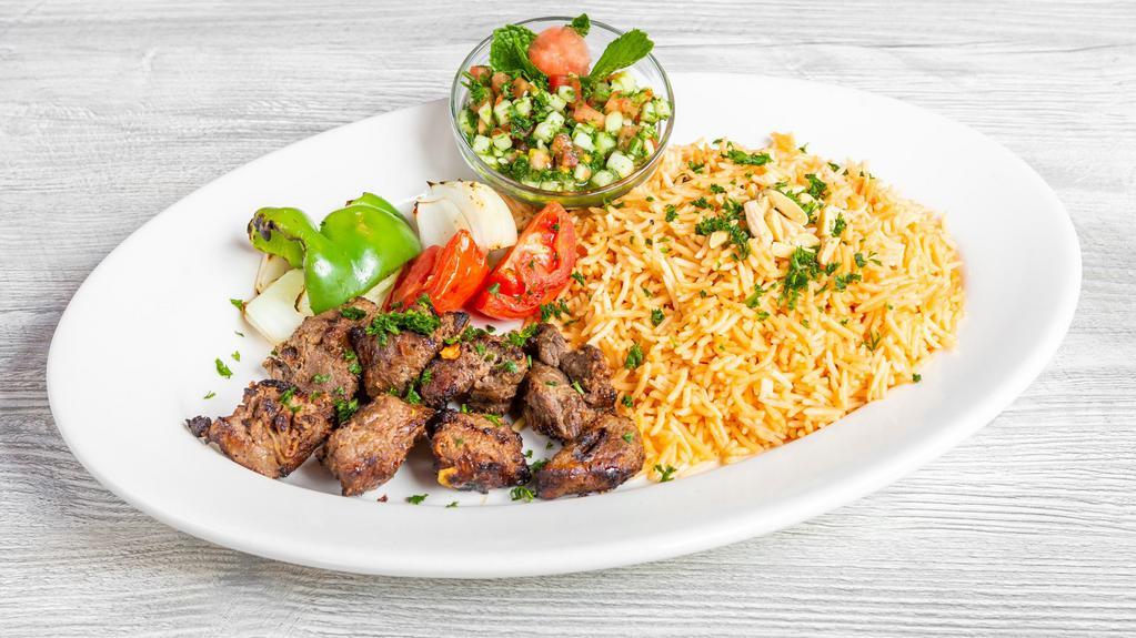 Shish Kabob /  شیش کباب- Platter · Marinated beef cubes charbroiled to perfection, served with grilled veggies. (two skewers).   Comes with our seasoned rice and your choice of side salad