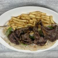 Lamb Chops /  ریش- Wrap · Four lamb chops marinated with our special house seasoning.  Comes on a freshly baked taboun...