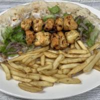 Chicken Shish Tawook Wrap · 2 skewers of marinated chicken breast cubes charbroiled to perfection. Served with grilled v...
