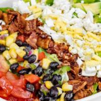 Cobb Salad · chopped romaine, bacon, tomatoes, blue cheese, black bean  corn salsa, diced egg, and avocado