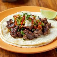 Carne Asada(Steak) Taco · Steak marinated in Modelo® topped with guacamole, cilantro, & onion. Served with salsa roja ...