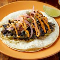 Portabello Poblano(Vegetarian) Taco · Grilled marinated portabello mushrooms, poblano peppers, and caramelized onions. Topped with...