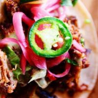 Pork Carnitas · Green salsa and pickled red onion.