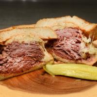 Reuben · Steamed corned beef  sour kraut and swiss cheese, on grilled rye with russian dressing.