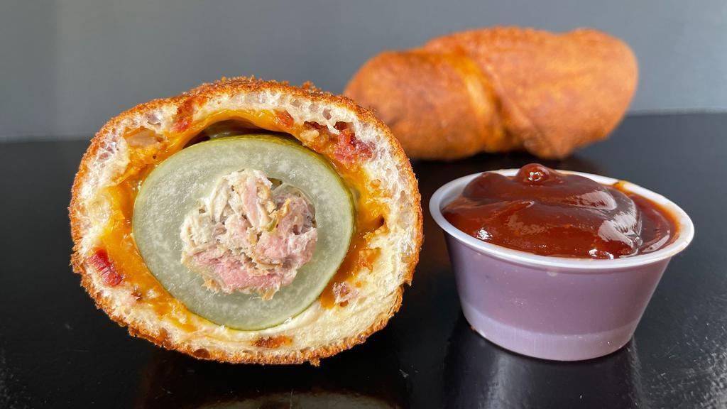 Porky Dill Dough · Cored Dill Pickle stuffed with Hickory Smoked Pork, rolled in a Cheddar and Bacon infused Dough then fried crisp