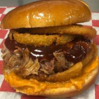 Bbq Pork Sandwich · Hickory Smoked Pork tossed with BBQ sauce, Onion Rings, and Cheddar Cheese spread on a Brioc...
