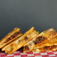 Al Pastor Quesadilla · Chorizo, Onion and Pineapple melted with Chihuahua Cheese in a Flour Tortilla.