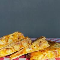 Gringo Quesadilla · Creamy Mac and Cheese, Crumbled Bacon and BBQ sauce with Cheddar Cheese in a Flour Tortilla.