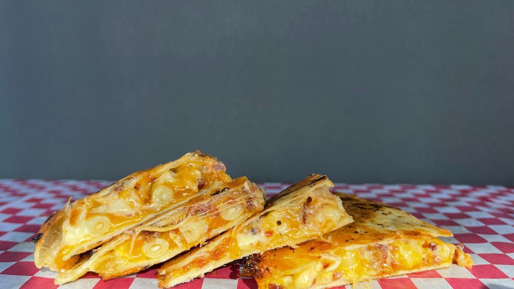 Gringo Quesadilla · Creamy Mac and Cheese, Crumbled Bacon and BBQ sauce with Cheddar Cheese in a Flour Tortilla.