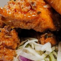 Chicken Sandwich · Crispy chicken strips drenched in housemade sweet + spicy ginger chili sauce. Laid on a bed ...