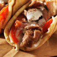 Gyros On A Pita Combo · Gyros sandwich with fries and small drink.
