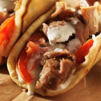 Gyros Sandwich · Gyros meat on a hot pita bread with onions, tomatoes, and topped with our own gyros sauce.