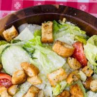 Caesar Salad · Crisp romaine lettuce tossed with garlic croutons, grated Parmesan cheese & our famous Caesa...