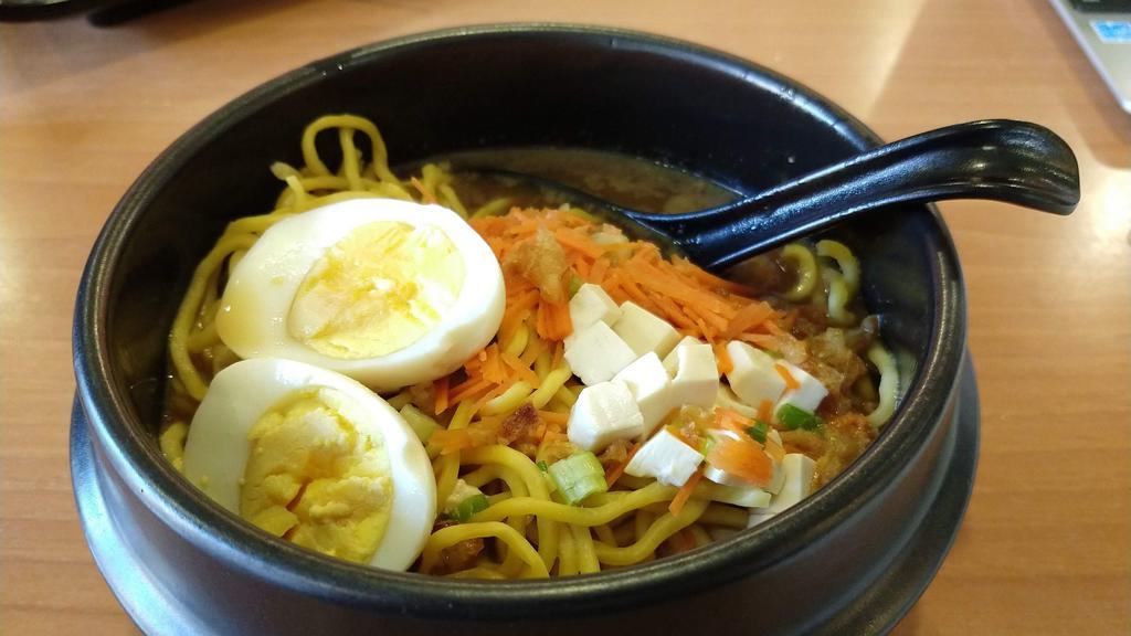 Chicken Katsu Ramen · Cooked. Crispy chicken, noodles, tofu, hard-boiled egg, green onion, nori flakes, & carrot in chicken & pork base.