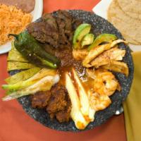 Molcajete · Sizzling hot lava rock filled with steak, chicken, chorizo, shrimp, onions, cactus, panela c...