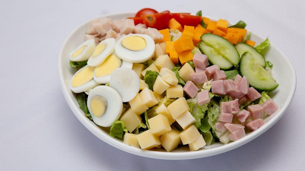 Chef Salad  · Ham, Turkey, Swiss and Cheddar cheese, cherry tomatoes, hard boiled egg, garlic herb croutons .. choice of dressing