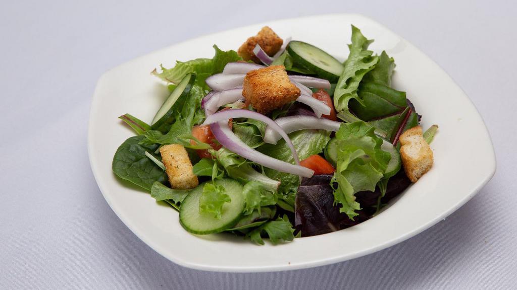 Mixed Green Salad · Arugula, spinach, frisée, radicchio and other baby greens below Roma tomatoes, cucumber, onion and garlic herb croutons. Choice of dressing.