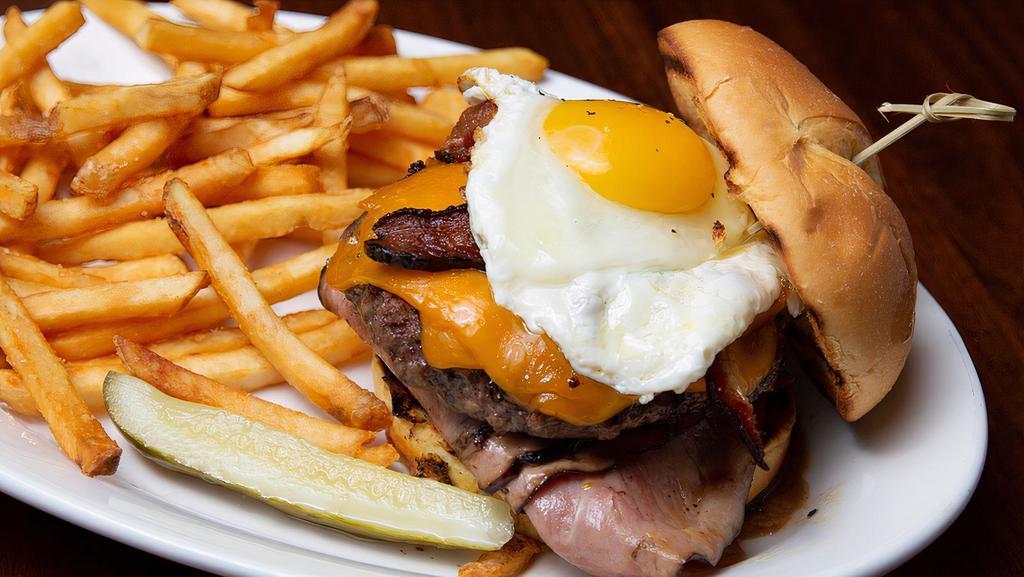 Breakfast Burger · 1/2 lb. burger with grilled ham, bacon, fried egg, and hashbrown cake on a brioche burger bun. Top with cheese. Served with fries.